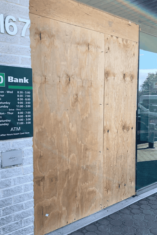Emergency commercial board-up service securing a damaged storefront opening