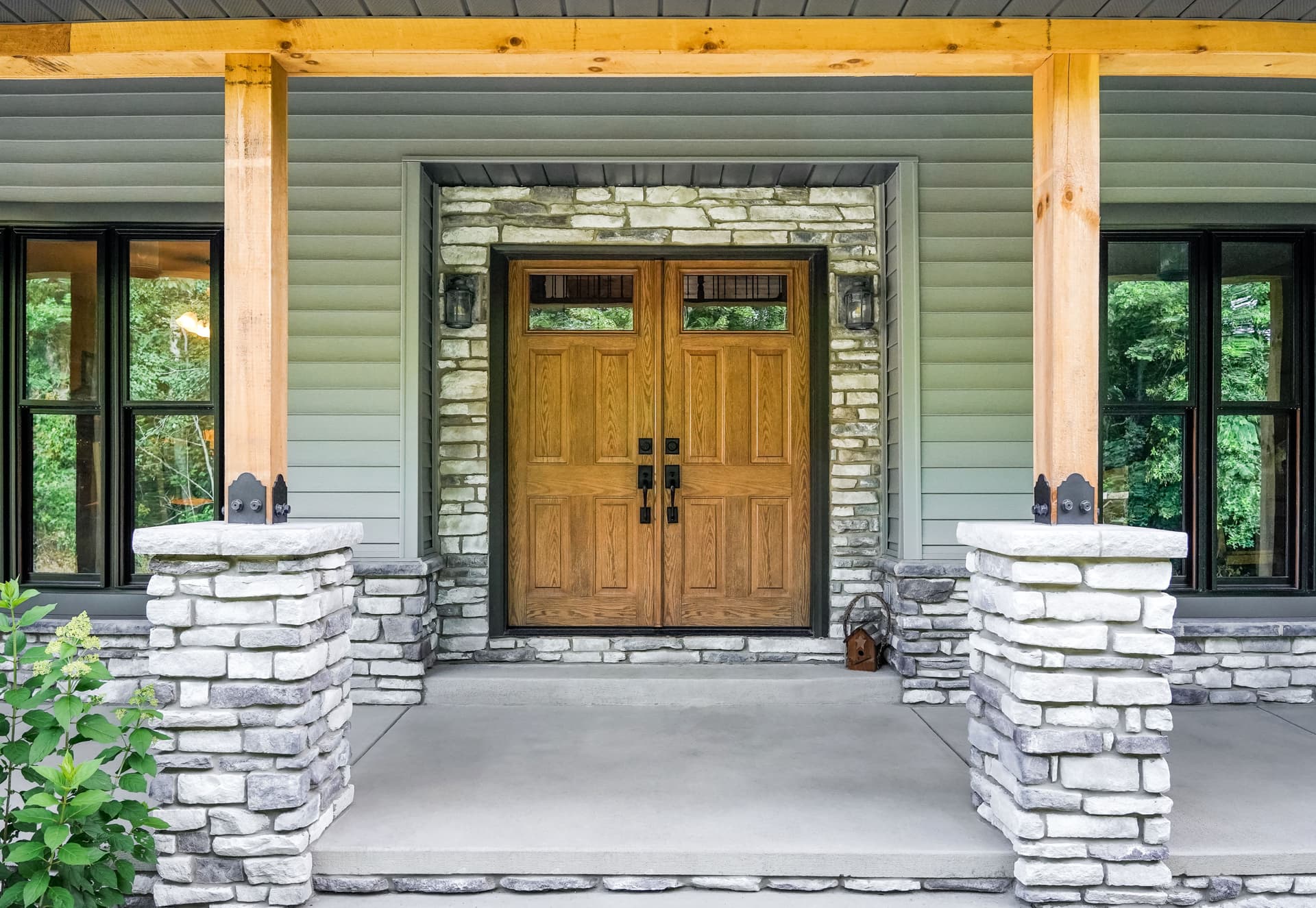French style entry door, with wood grain, black hardware.