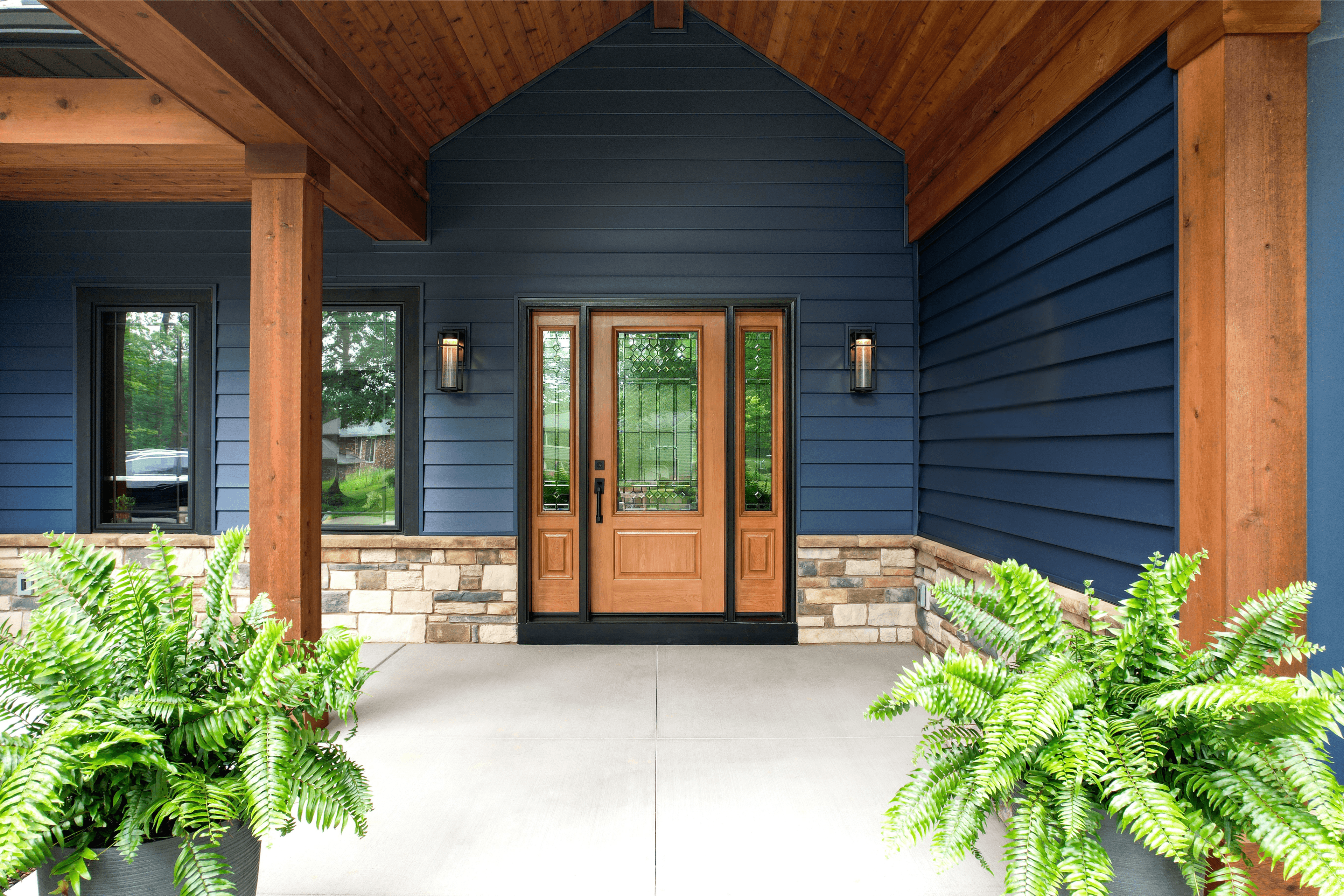 Entry door featuring a warm Earth-tone stain, 2 sidelites, and large glass panels that match on both door and sidelites.
