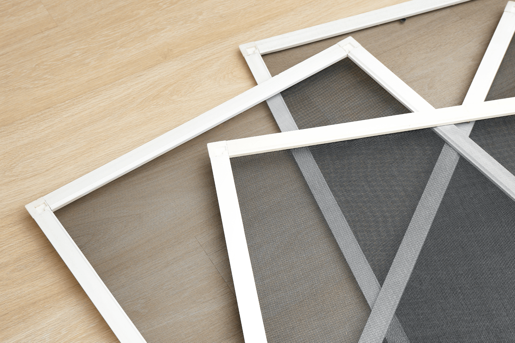 3 door screens stacked and fanned out on the floor